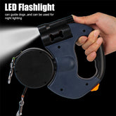 Hand holding a retractable dog leash for small dogs with an LED flashlight feature for night safety.