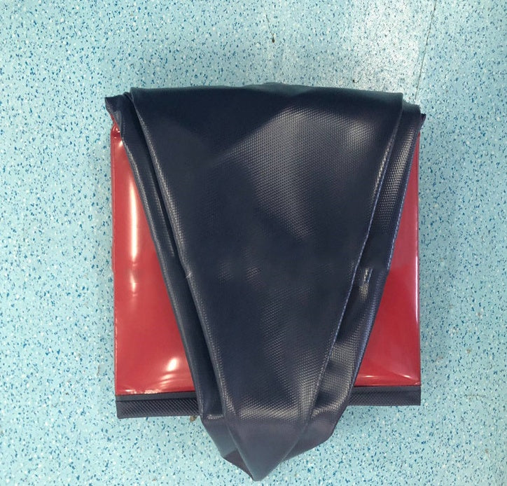 Foldable dog swimming pool, portable and durable design, displayed in a folded position on a blue surface.