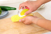 Corn kernel separator kitchen gadget for easy removal of kernels from corncobs, featuring a plastic shell and stainless steel blade.