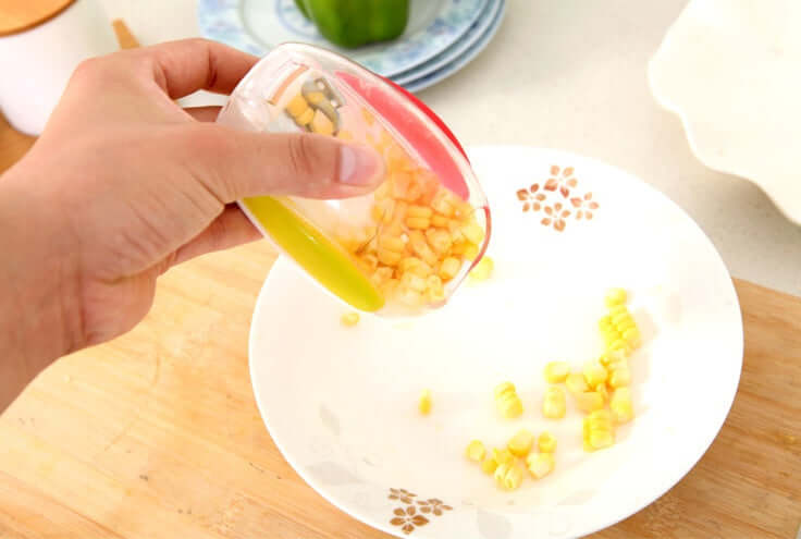 Corn kernel separator kitchen gadget for easy removal of kernels from corncobs, featuring a plastic shell and stainless steel blade.