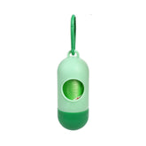 Green dog poop bags for cleanup dispenser with hanging loop and visible trash bag inside.