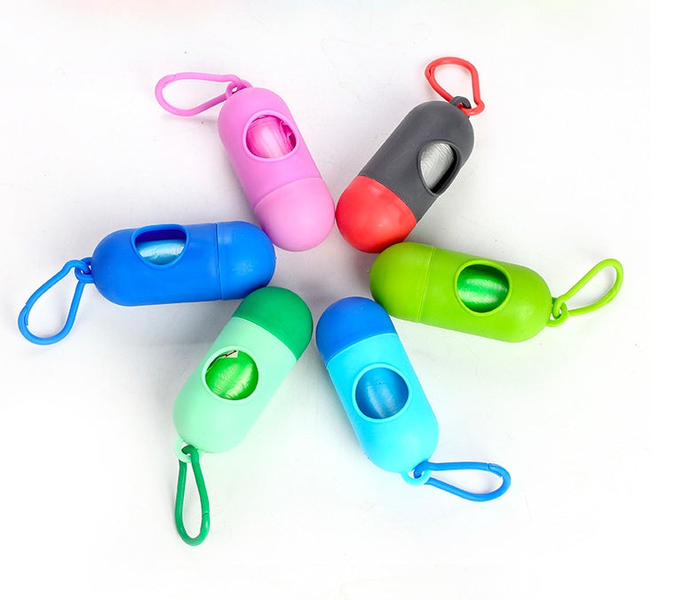 Colorful dog poop bags for cleanup holders in pink, gray, green, and blue.