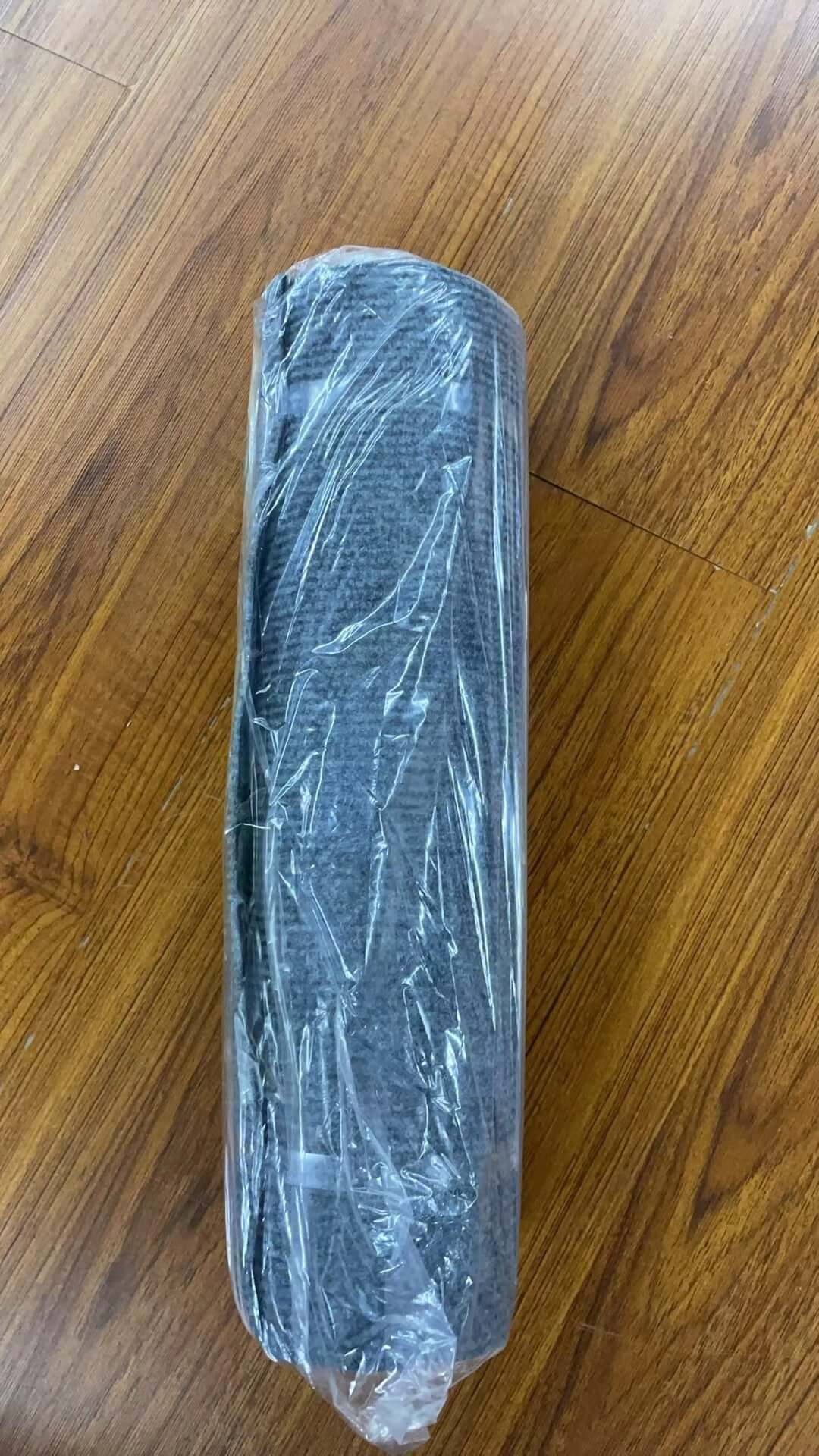 Self-Adhesive Carpet Cats Scratch Board for Sofa Protection rolled in protective plastic on wooden floor.